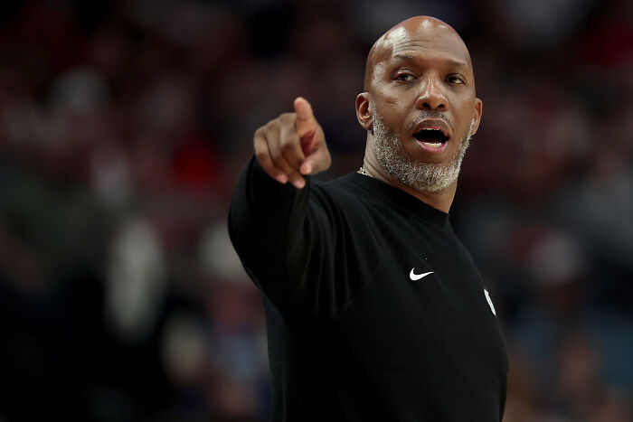 Man in black Nike shirt gesturing during an NBA game related to FBI dual NBA gambling cases and insider bets.