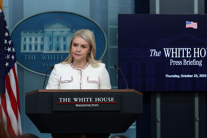 Woman at The White House podium during a press briefing, related to Trump&rsquo;s granddaughter revealing his hand problems timeline.