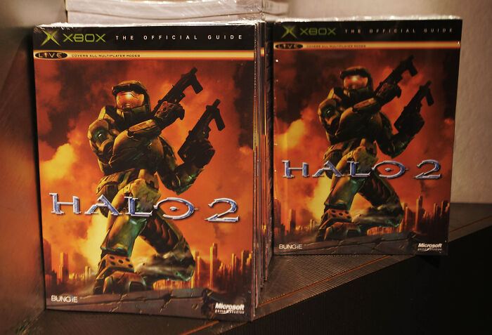 Halo 2 Xbox game covers displayed on a shelf representing developers' criticism of game-themed ICE recruitment adverts.