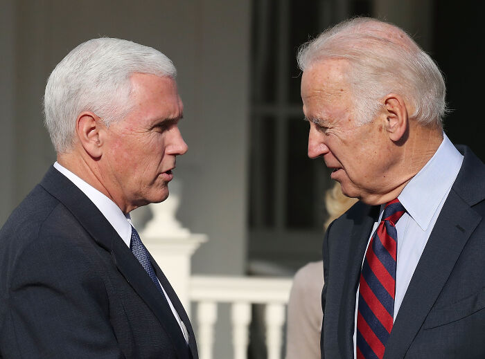 Mike Pence and Joe Biden engaged in a serious conversation outdoors, related to Trump called Pence wimp January 6 notes.