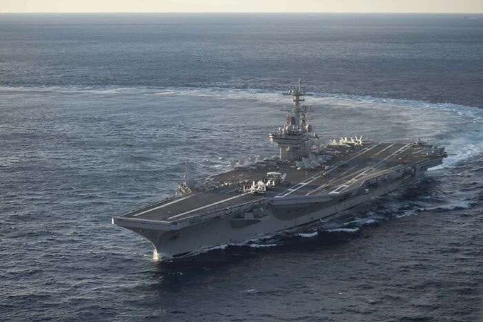 Aircraft carrier sailing in open ocean, relevant to Trump rant about magnets and steam aboard military ship.