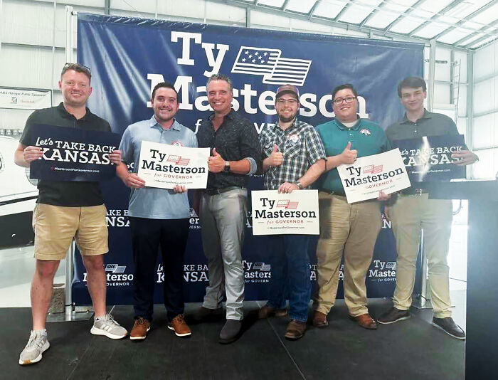 Group of young men holding Ty Masterson for Governor signs at a rally, related to young Republican leaders racist remarks report