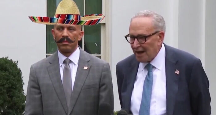 Two politicians standing outdoors during a government shutdown as blame game between Dems and GOP escalates.