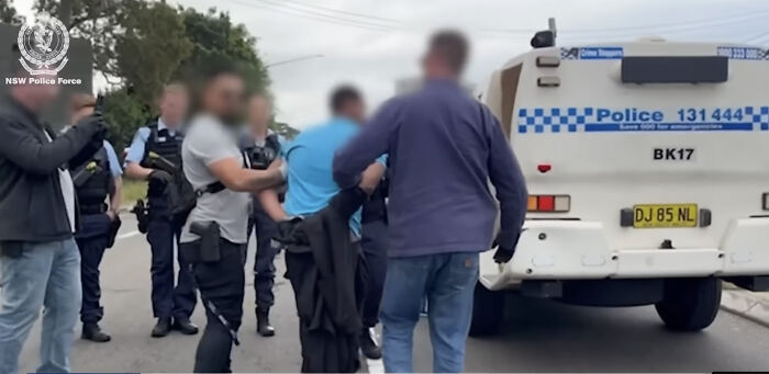 Police intercept a team of alleged assassins in footage showing their capture en route to a daycare center.