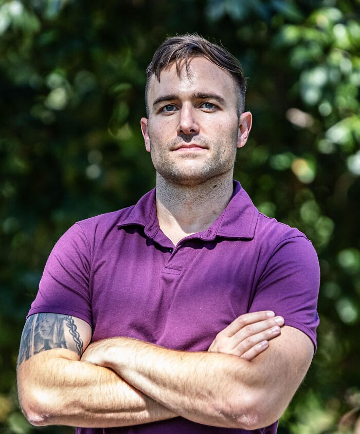 National Guard troop standing outdoors with arms crossed, determined expression, defying Chicago deployment order.