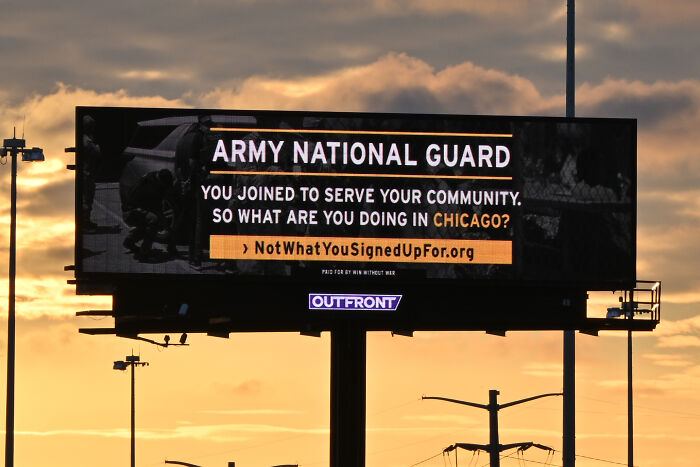 Billboard about Army National Guard with message questioning service in Chicago, related to elementary school teacher viral protest.