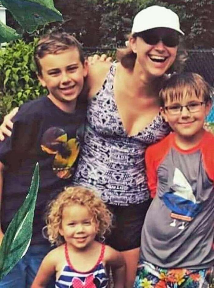 Family photo of a woman with three children smiling outdoors, related to Florida man news involving unalived family members.