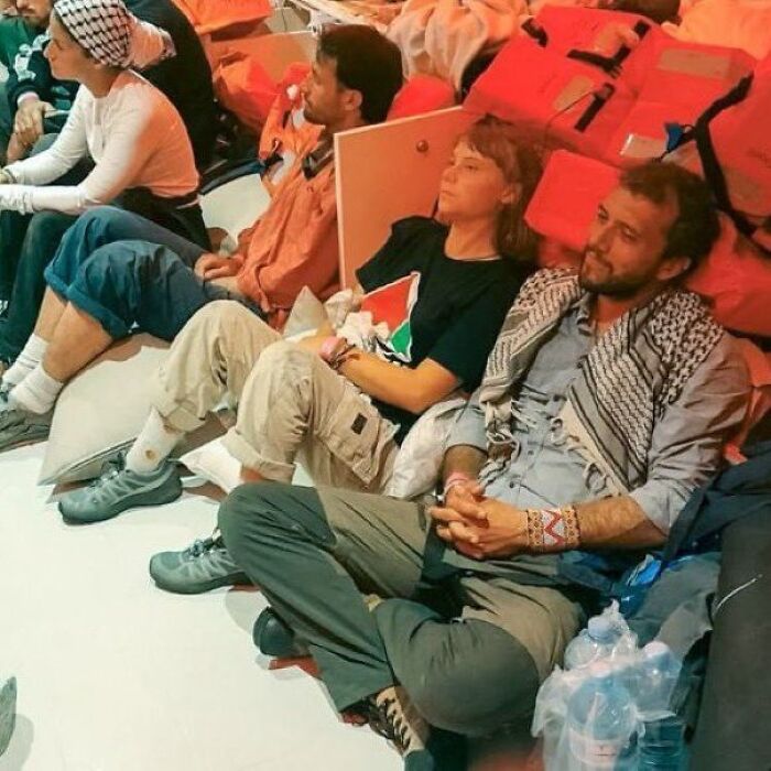 Greta Thunberg seated with activists after Israeli navy intercepted Gaza-bound flotilla at sea.