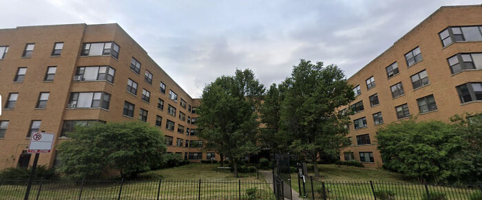 Federal agents outside a Chicago apartment building during an immigration raid arresting multiple individuals overnight.