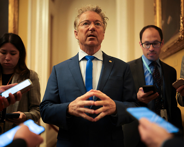 Senator speaking to reporters inside a government building amid warnings of war in Venezuela and military buildup.