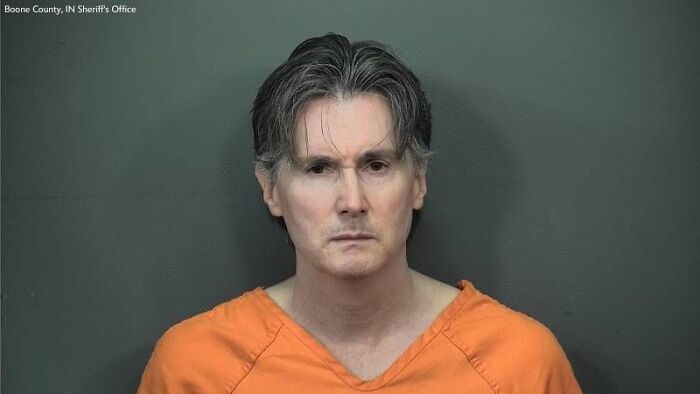 Mugshot of Indiana man charged with shooting house cleaner who arrived at the wrong home, wearing orange jail uniform.