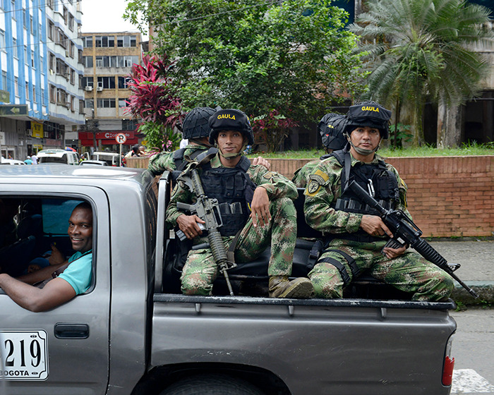 Armed police in tactical gear riding in the back of a pickup truck during a rescue operation from Lev Tahor sect.