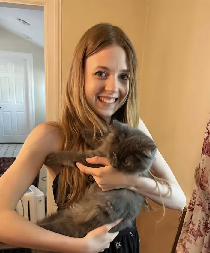 Bethany MaGee, 26, smiling and holding a gray cat indoors, related to Chicago woman set ablaze on train incident.