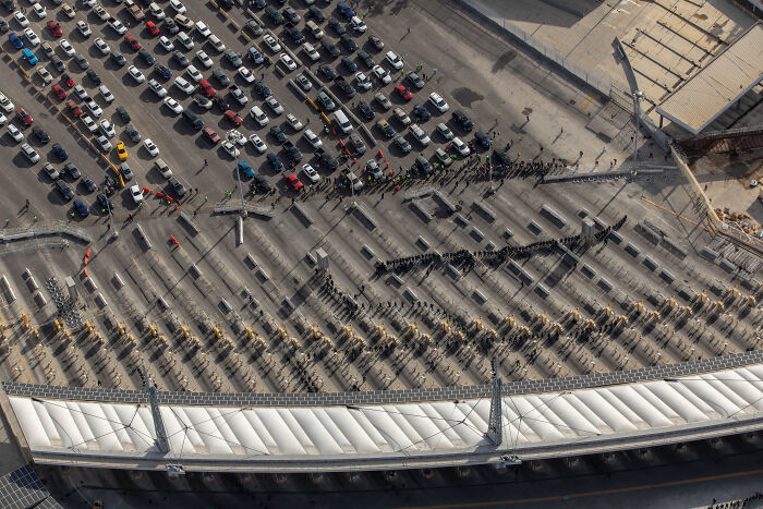 Aerial view of a crowded vehicle checkpoint with officials inspecting cars amid White House Venezuela fentanyl supply concerns.