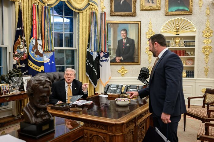 Donald Trump seated in the Oval Office with another man, social media noticing something bizarre in the pictures.