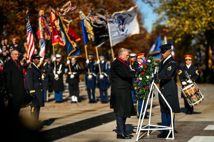 Donald Trump honors fallen heroes with a Veterans Day tribute, featuring military honors and a ceremonial wreath.