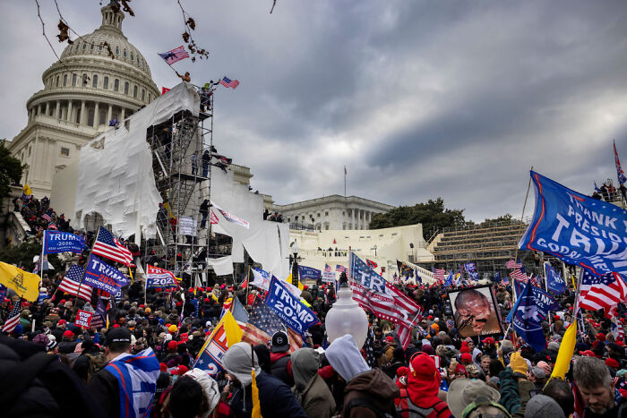 Crowd at the US Capitol with Trump 2020 flags on a cloudy day, illustrating Truth Social AI tool calls BS on Donald Trump claims.