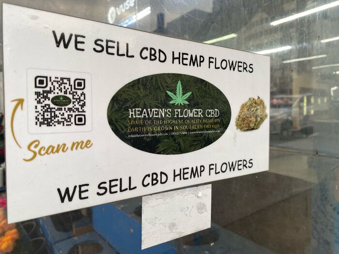 Sign advertising CBD hemp flowers from Heaven's Flower CBD, highlighting a family source of income and government impact.
