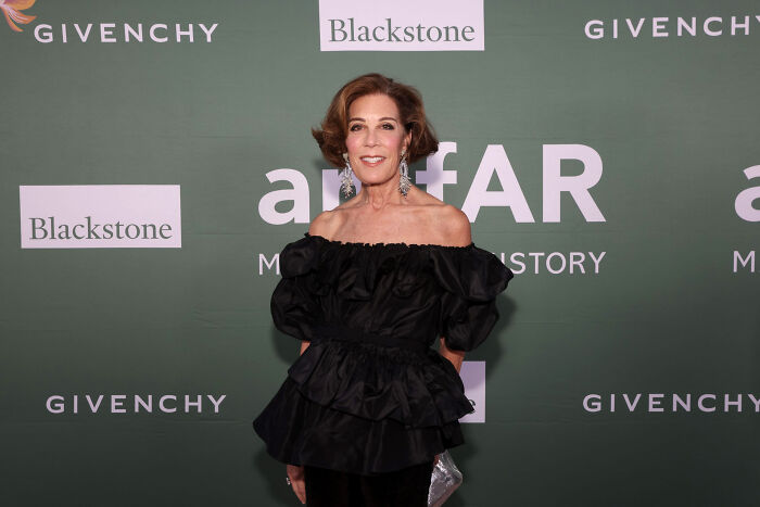 Woman posing at an event, representing influential people appearing in Epstein emails who rarely make headlines.