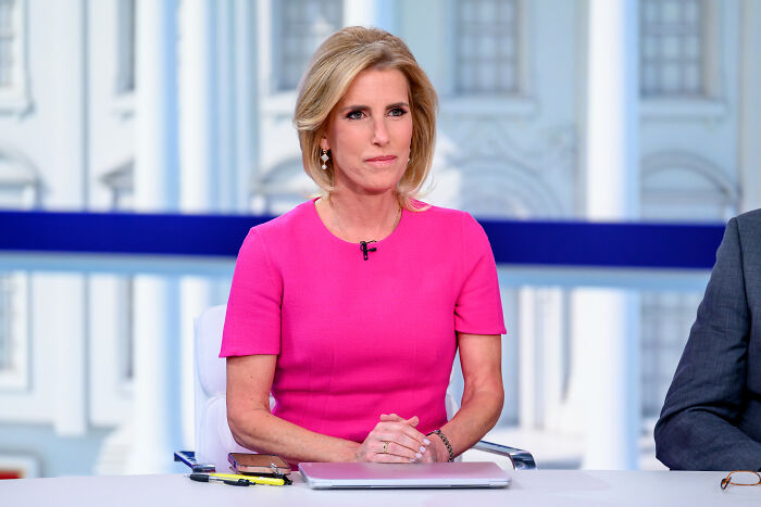 Fox host Laura Ingraham in a pink dress during tense on-air exchange from the White House studio setting.