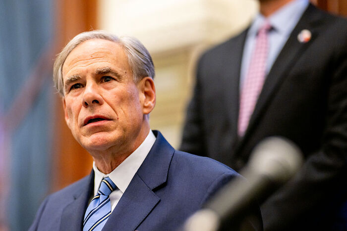 Man in suit and striped tie speaking at a formal event about Texas racially gerrymandered map and federal court ruling.