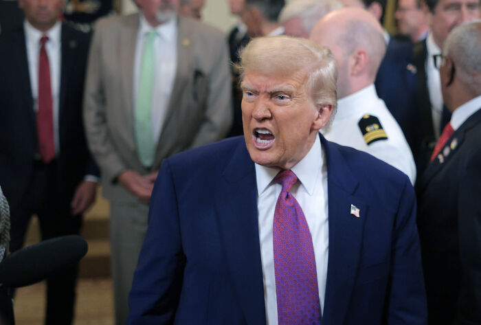 Former President Trump speaking passionately in a crowded room on US policies related to fentanyl supply and Venezuela crackdown.