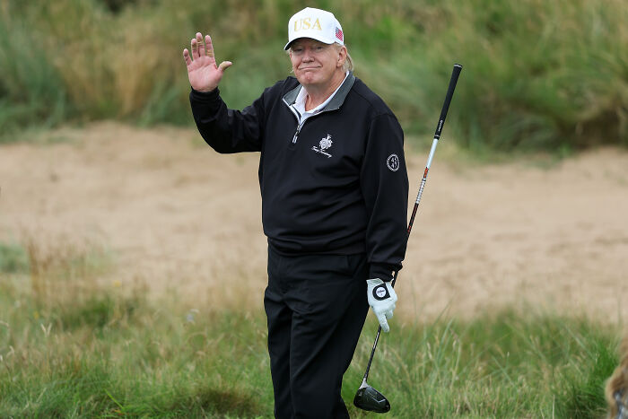 Donald Trump on a golf course waving, highlighting Trump golf trips cost taxpayers millions in government expenditures.