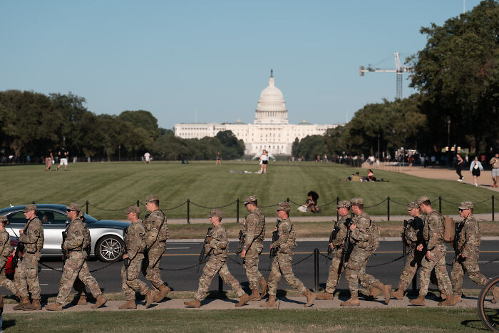 National Guard troops marching near the Capitol in Washington as ordered to remain until end of February by Donald Trump.