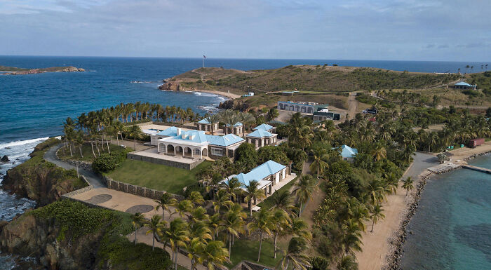 Aerial view of a secluded coastal estate linked to influential people appearing in Epstein emails, surrounded by ocean and greenery.