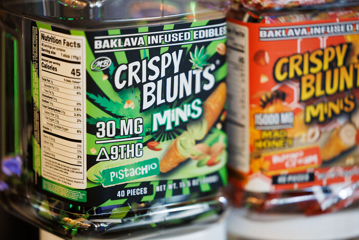 Container of Crispy Blunts mini edibles with THC, highlighting products linked to people crushed by government actions.