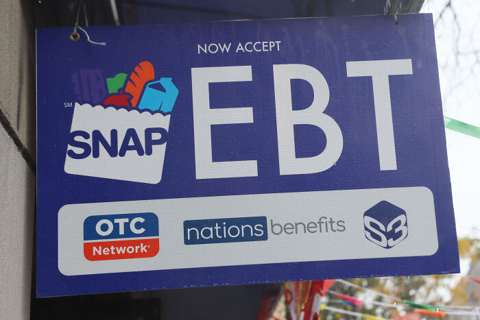 Sign displaying SNAP EBT acceptance, highlighting benefits related to nutrition assistance and OTC Network support.
