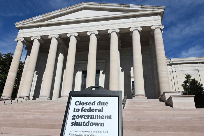 Government building with sign stating closed due to federal government shutdown amid criticism over SNAP cuts and social media posts.