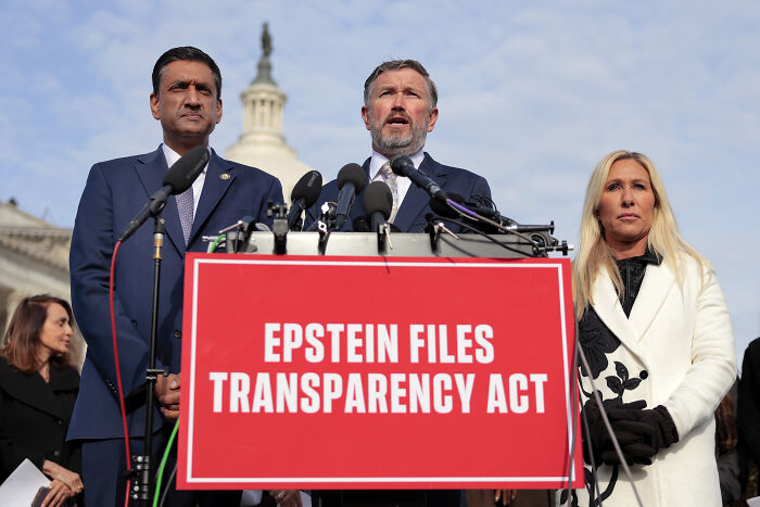 Three politicians at a press conference with Epstein Files Transparency Act sign discussing Republican lowlifes and GOP unity.