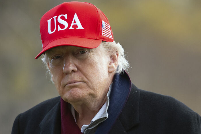 Donald Trump wearing a red USA hat outdoors, expressing support for the return of a Hollywood movie franchise.