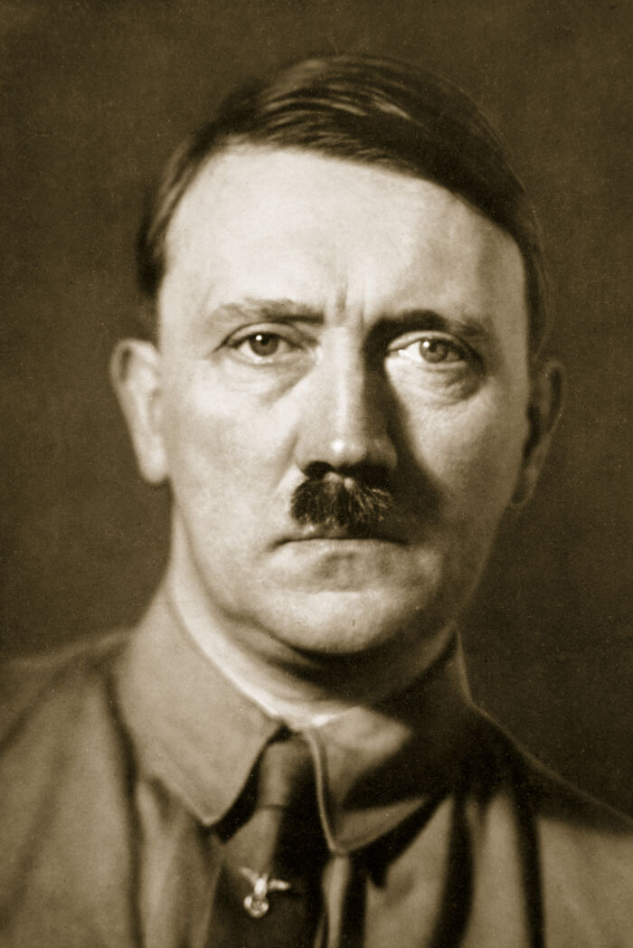 Sepia portrait of Hitler with focus on facial features linked to rare genetic disorder affecting manhood size.