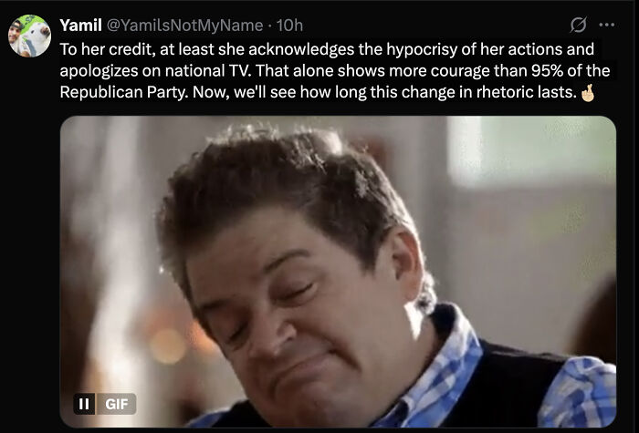 Man with closed eyes and a smirk in a blue checkered shirt, reacting to Marjorie Taylor Greene&rsquo;s response viral moment.