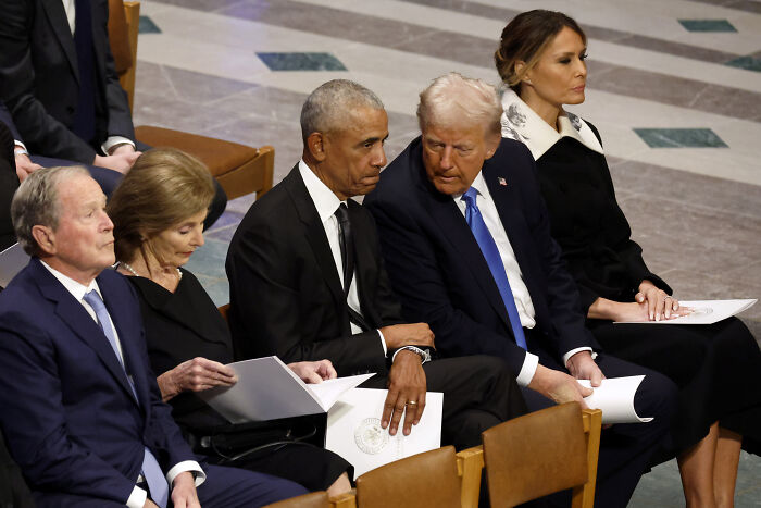 Former presidents Obama and Trump seated next to each other at a formal event amid all-night rage posts about Obama.