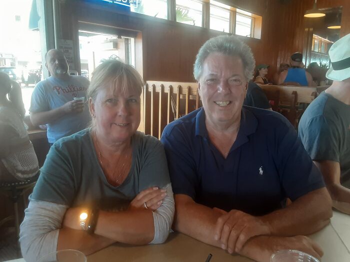 Middle-aged couple sitting at a restaurant table, relevant to daughter breaking silence after domestic dispute call news.