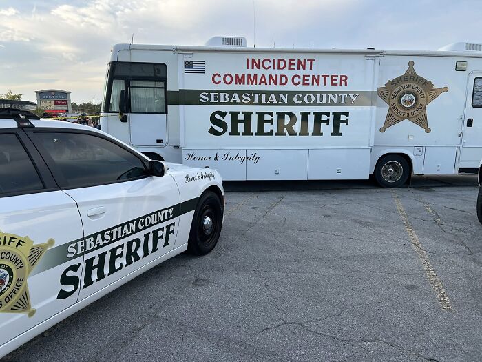Sebastian County sheriff vehicles at a mansion tragedy scene involving mom and twin 6-year-olds amid divorce dispute.