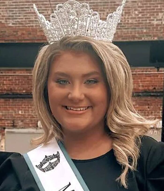 Smiling pageant queen wearing crown and sash, representing high-profile college dorm case involving partner&rsquo;s toddler.