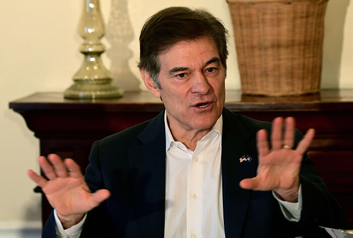 Dr. Oz speaking with expressive hand gestures, advising federal workers on eating less after government shutdown.