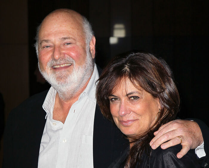 Rob Reiner smiling with a woman, showing support for progressive causes and political activism in a casual setting.