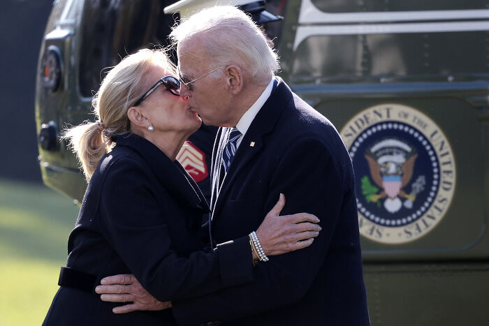 Joe Biden and Jill Biden embracing and kissing outdoors near a helicopter, related to daughter breaking silence after domestic dispute death.