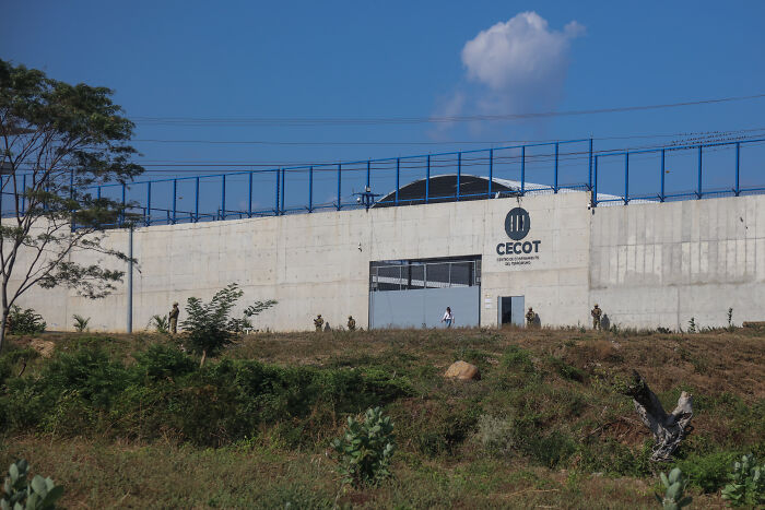 CE-COT detention center exterior with security fencing and guards, related to corporate censorship and deportation report backlash.