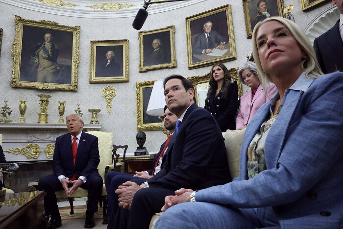 Trump&rsquo;s chief of staff sitting with officials in a formal room amid discussions on political and leadership issues.