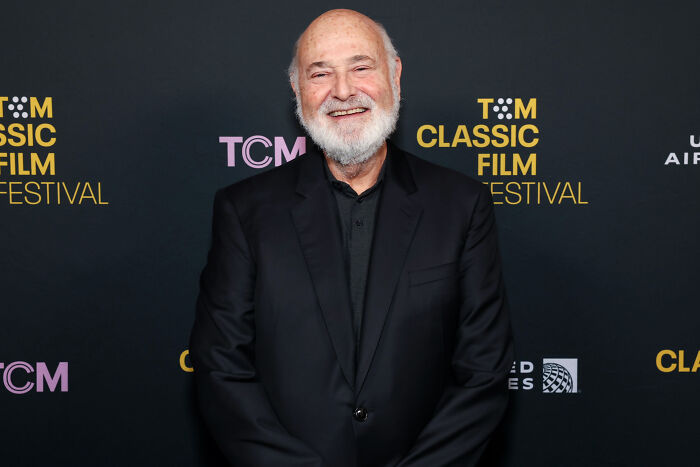 Rob Reiner smiling in a black suit at the TCM Classic Film Festival amid Trump remarks sparking outrage and MAGA base split.