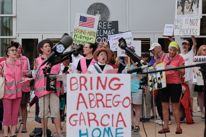 Protesters gather holding signs demanding the return of Kilmar Abrego Garcia, vowing to fight Trump admin policies.