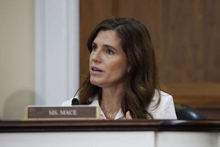 Nancy Mace speaking at a meeting, discussing the proposal to rename BLM Plaza for Charlie Kirk.