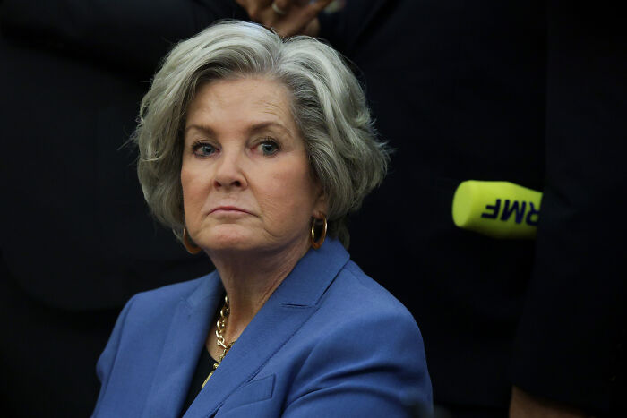 Woman with gray hair wearing a blue blazer at a formal event, related to Trump&rsquo;s chief of staff and alcoholic personality discussions.