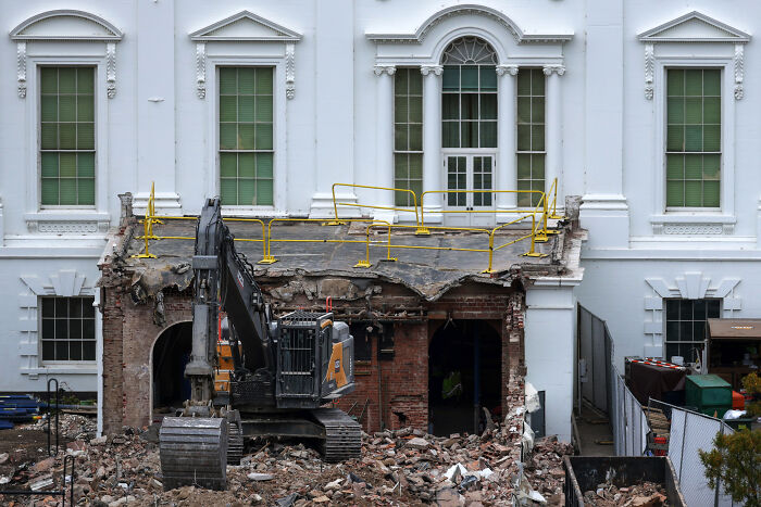 Excavator and debris outside White House during ballroom construction declared a security necessity by Trump administration.